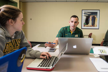 Photo of two Schar School students speaking