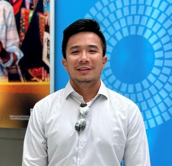 A photo of Angelo Gabrielle Santos wearing a white shirt in front of a blue background.